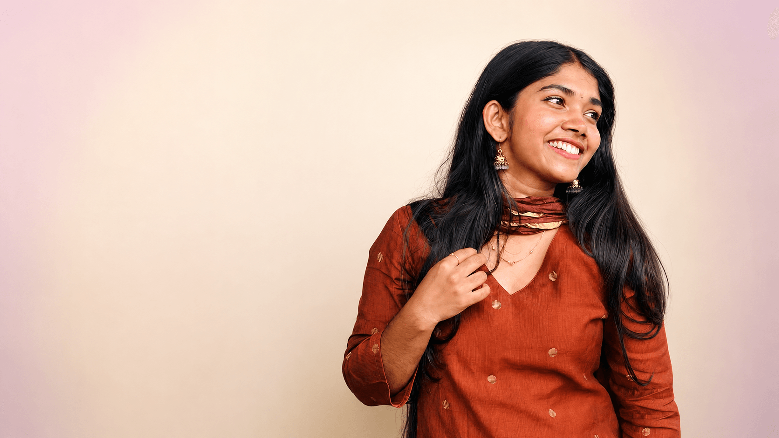 Woman wearing a rust polka dot kurta from DZANE